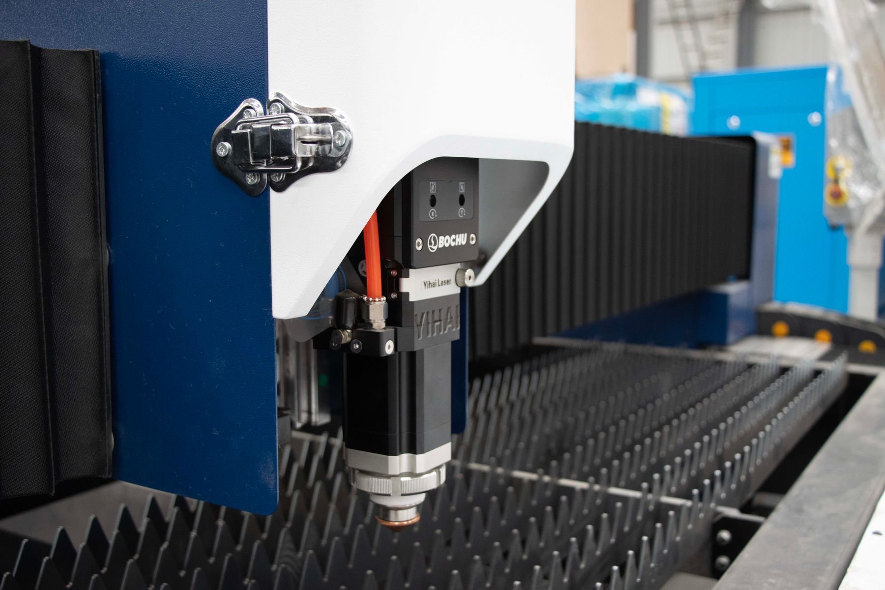 Fibre-laser cutting head over sheet steel.